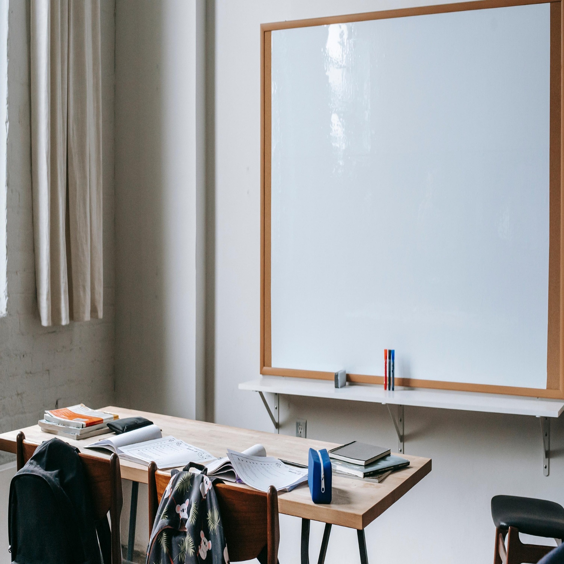 Empty classroom with a chalkboard and a single desk, symbolizing a quiet space for learning and reflection.